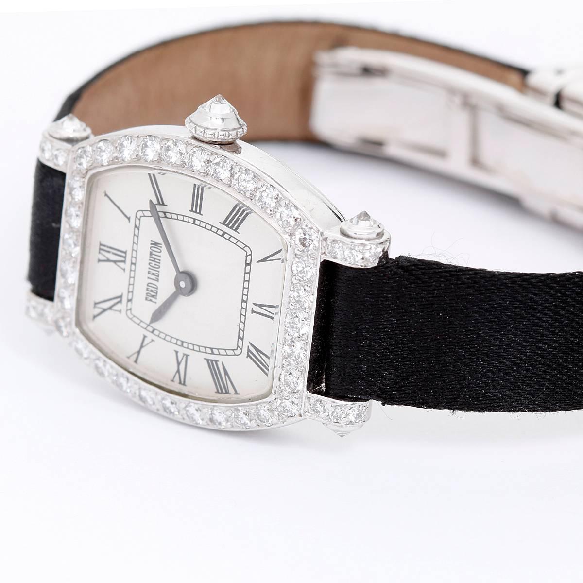 Fred Leighton by Charles Oudin Diamond Watch -  Quartz. 18K White Gold Tonneau case with 32 diamonds around bezel and on lugs ( 20 x 22 mm ). Enamel with Roman numerals. Black satin bracelet with diamond clasp. Pre-owned with custom box. Fits a 5