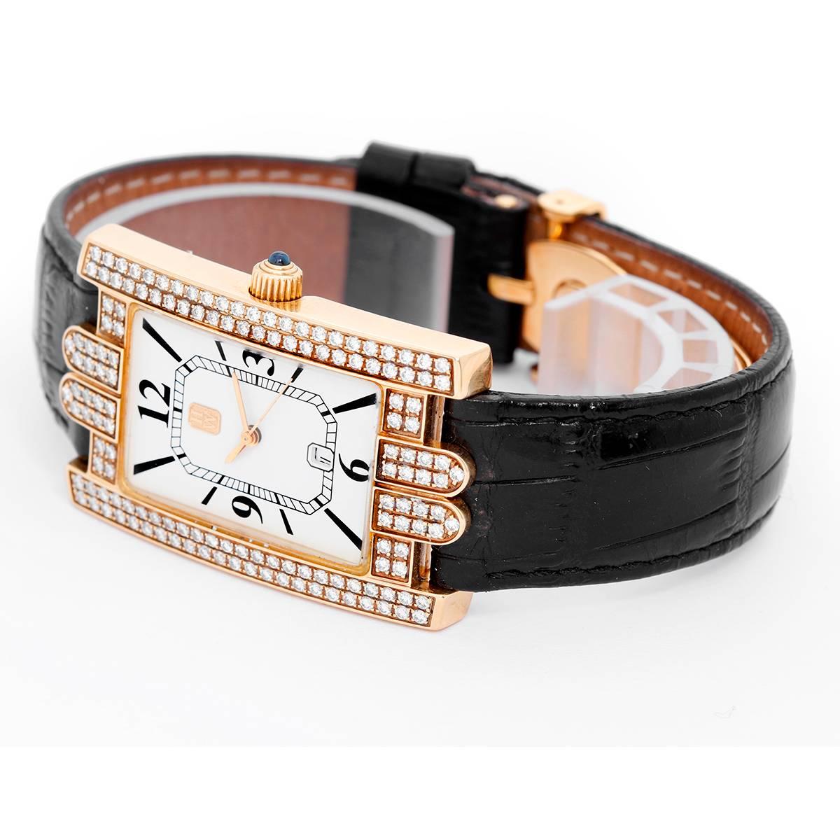 Harry Winston Avenue Classic Yellow Gold Watch -  Quartz. Yellow gold case with two rows of diamonds on bezel (38.5 mm x 27.5 mm). Enamel with Roman numerals at 3 o'clock, 9 o'clock, and 12 o'clock; Date at 6 o'clock. Black leather strap with Harry