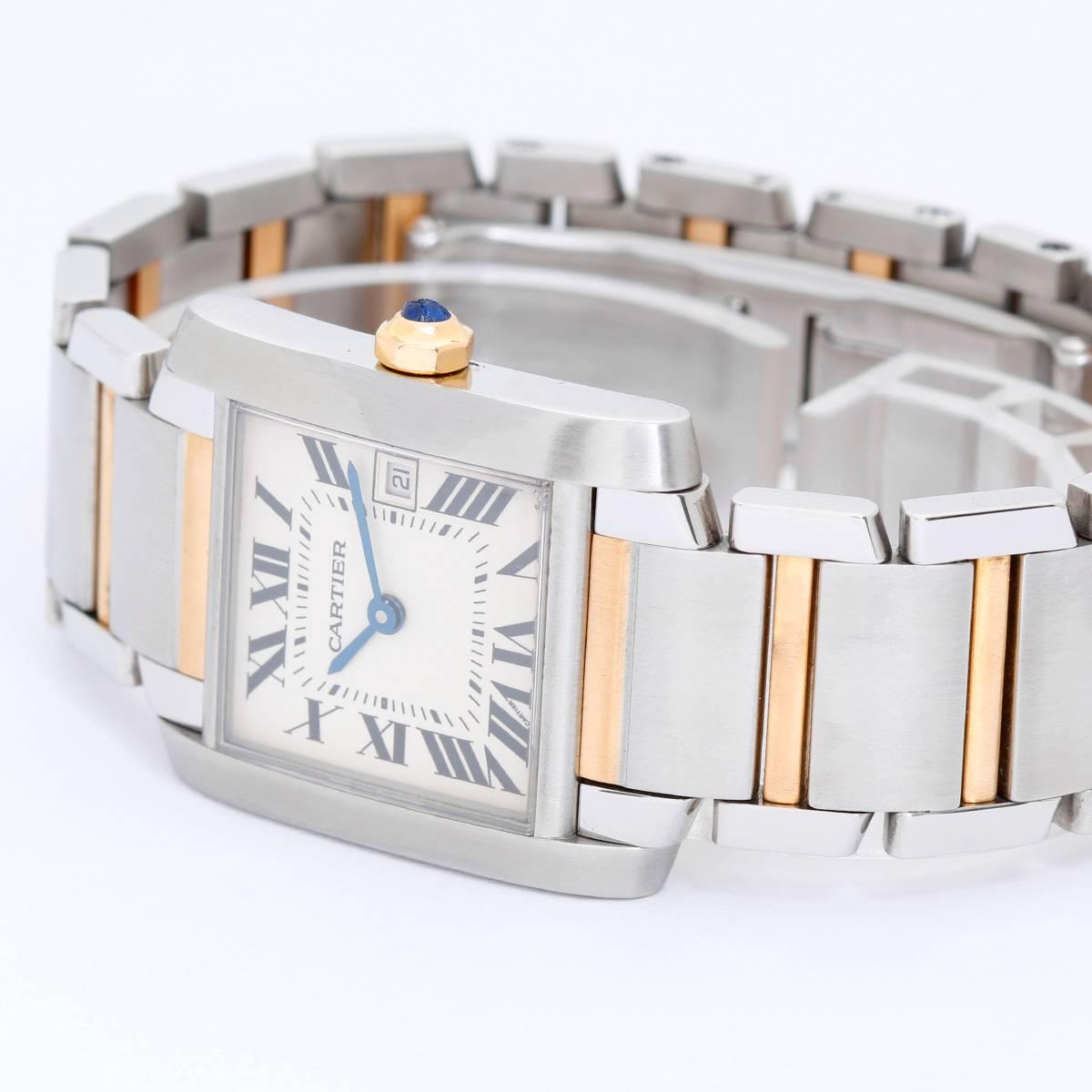 Cartier Tank Francaise Men's 2-Tone Watch W51005Q4 -  Quartz. Stainless steel case (28mm x 35mm). Silver guilloche dial with black Roman numerals; date at 3 o'clock. Stainless steel and 18k yellow gold Cartier bracelet with deployant buckle.