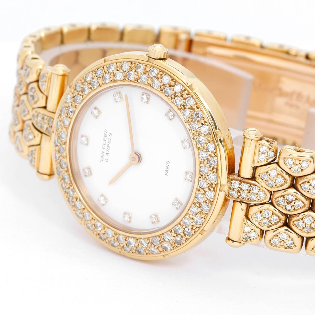 Van Cleef & Arpels Classique Paris Ladies Watch -  Quartz. 18K Yellow gold ( 31 mm ). White dial with diamond hour markers; two row diamond bezel. 18K Yellow gold diamond bracelet with double deployant buckle. Pre-owned with box.