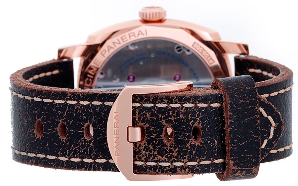 Manual winding. 18k rose gold case with exposition back (47mm diameter). Brown dial with stick markers; subseconds dial and date. Distressed leather strap band with 18k rose gold Panerai buckle. Pre-owned with box and papers.