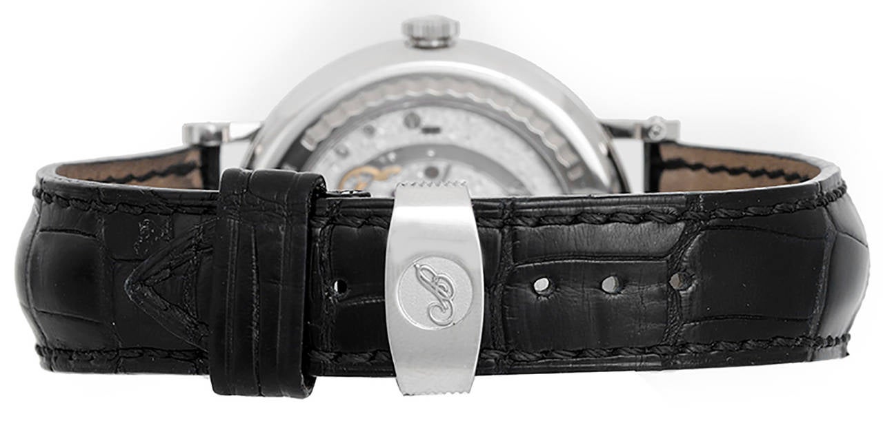 Automatic winding. 18k white gold case with exposition back  (39mm diameter). 2-Tone silvered dial with black Roman numerals; day, date, month, moonphase; leap year and power reserve indicators. Strap band with 18k white gold Breguet deployant