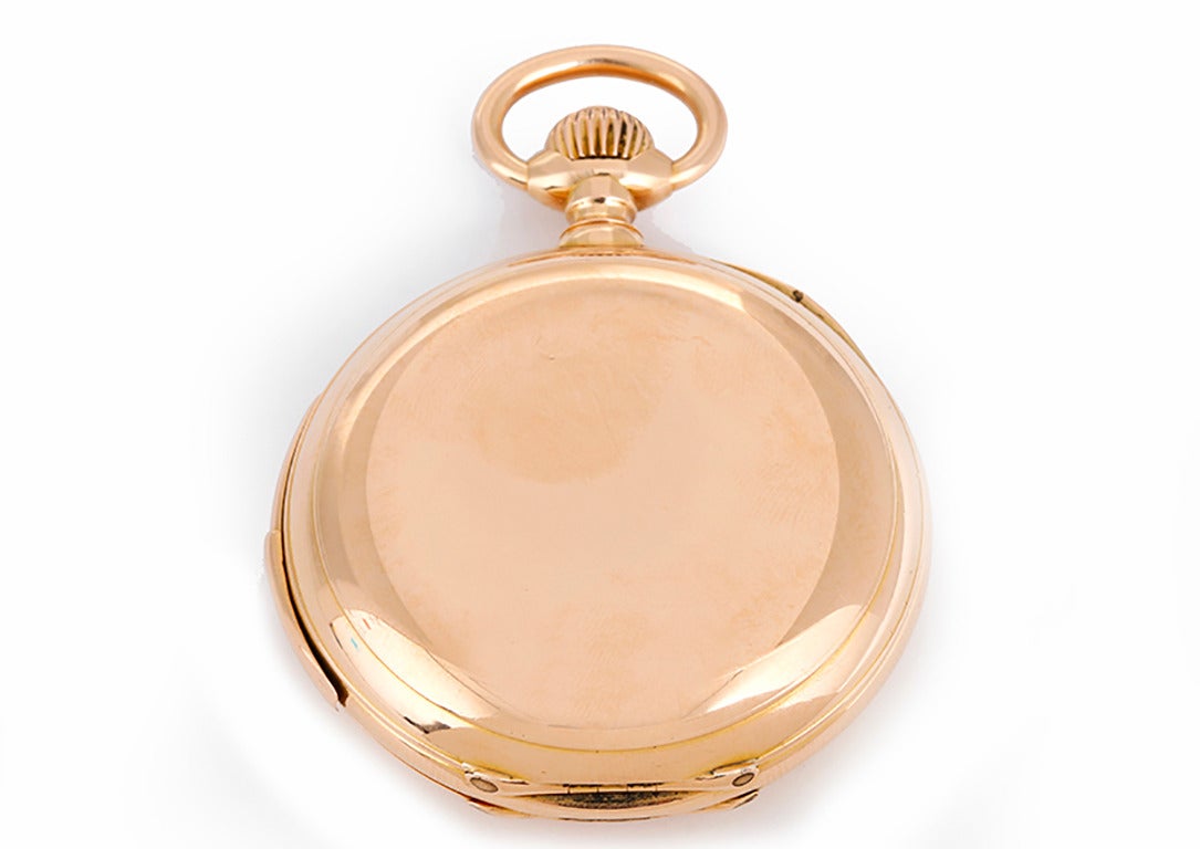 Manual winding; quarter hour repeater. 18k rose gold hunting case with glass inner back to view movement (52mm diameter). White enamel dial with black Roman numerals. Pre-owned with custom box. A fine Swiss repeater pocket watch circa 1920s.