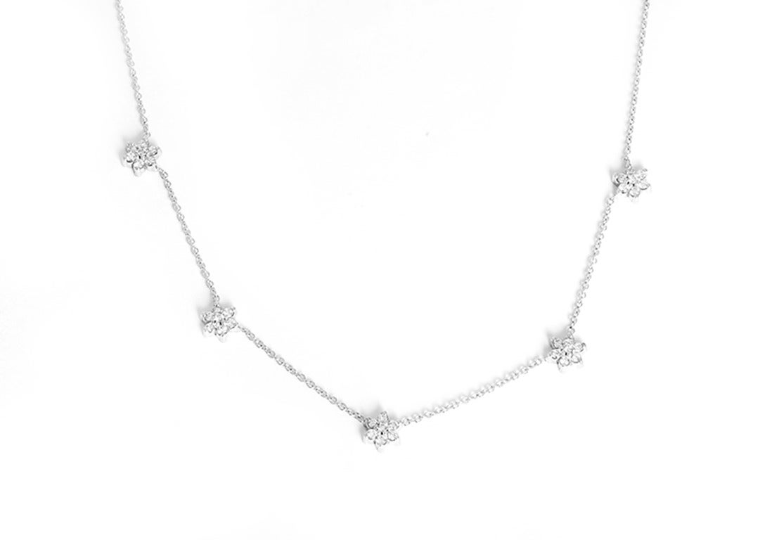 This amazing fleurette necklace features  apx. 1.2 ctw. of five flower motifs (each made up of 7 diamonds) set in 14k white gold.  The necklace measures apx. 19-inches in length. Total weight is 6.3 grams.