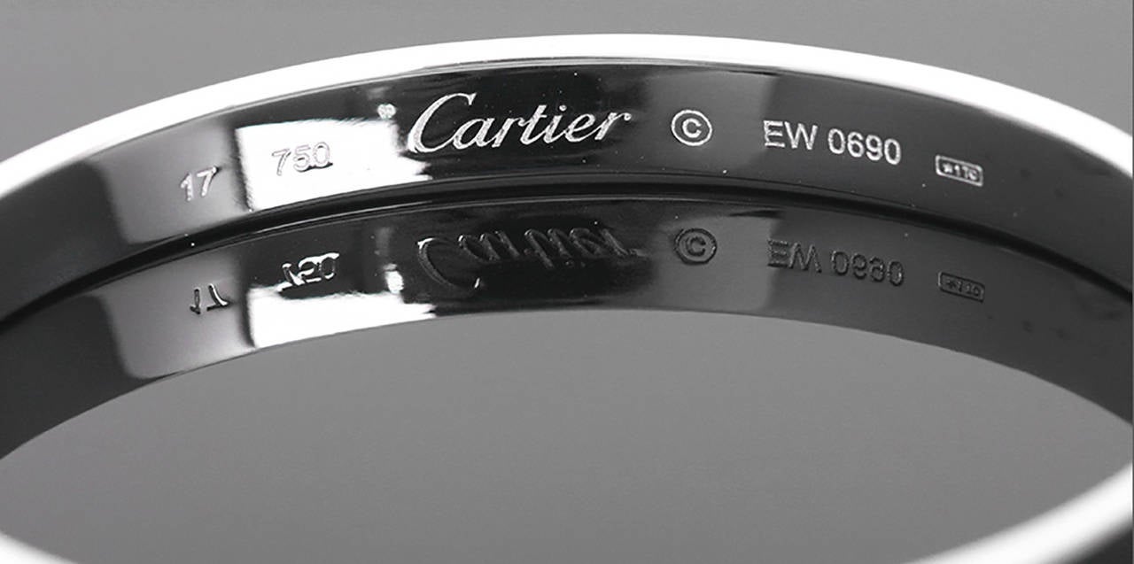 This bracelet is stamped Cartier, 750, 17 and EW0690. It does not come with the screwdriver but can be opened and closed with an eyeglass screwdriver as well. It is in perfect condition!  Size 17.