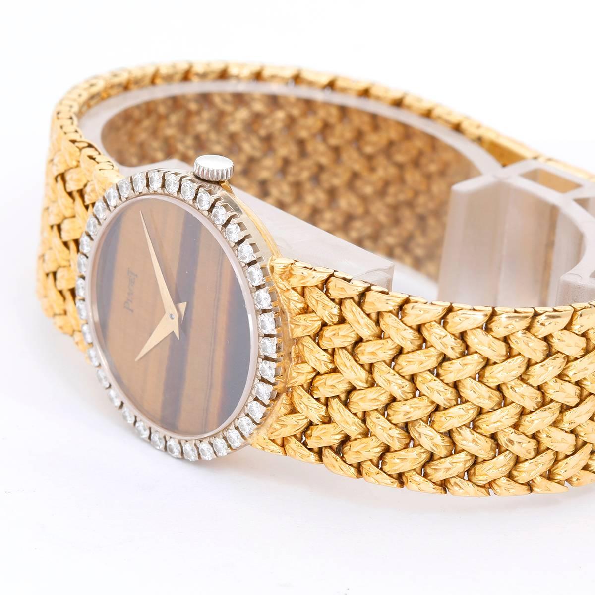 Piaget 18K Yellow Gold Tiger's Eye Dial Ladies Watch -  Automatic. 18K Yellow Gold (24 mm ). Tiger's eye dial with a diamond bezel. 18K Yellow Gold piaget mesh bracelet. Pre-owned with box.
