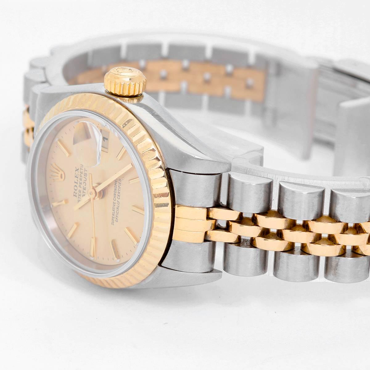 Rolex  2-Tone Datejust Steel & Gold Ladies Watch 69173 -  Automatic winding, 29 jewels, Quickset date, sapphire crystal. Stainless steel case with 18k yellow gold fluted bezel  (26mm diameter). Champagne dial with gold stick markers. Stainless steel