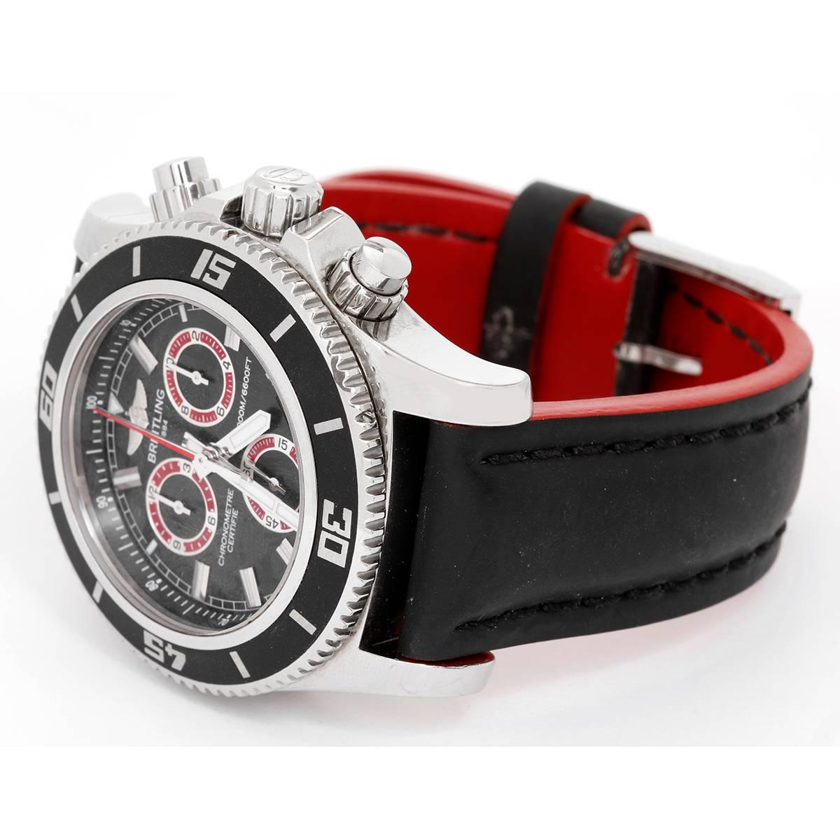 Breitling Superocean Chronograph M2000 Mens Watch A73310A8 -  Automatic winding, Chronograph. Stainless steel case with rotating bezel with black insert (46mm diameter). Black dial with red rim subdials. Breitling black and red  strap with Breitling