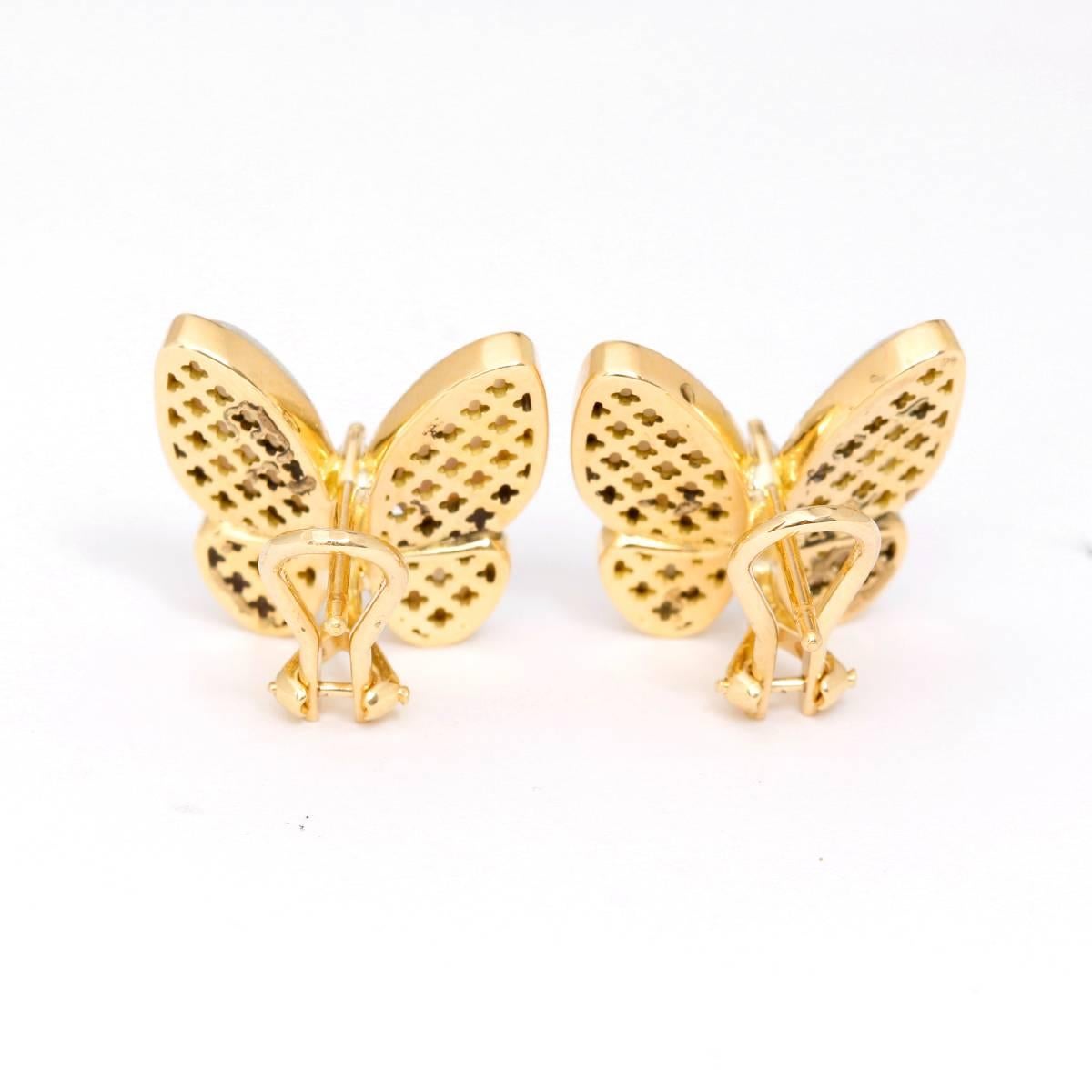 18K Yellow Gold Mother Of Pearl  Diamond Butterfly Earrings - . Two Butterfly earrings with Mother Pearl and a diamond middle. 2 Yellow gold earrings weighing  1.42cts diamonds. Omega backs. Total weight 7.5 grams. These dazzling pieces combine