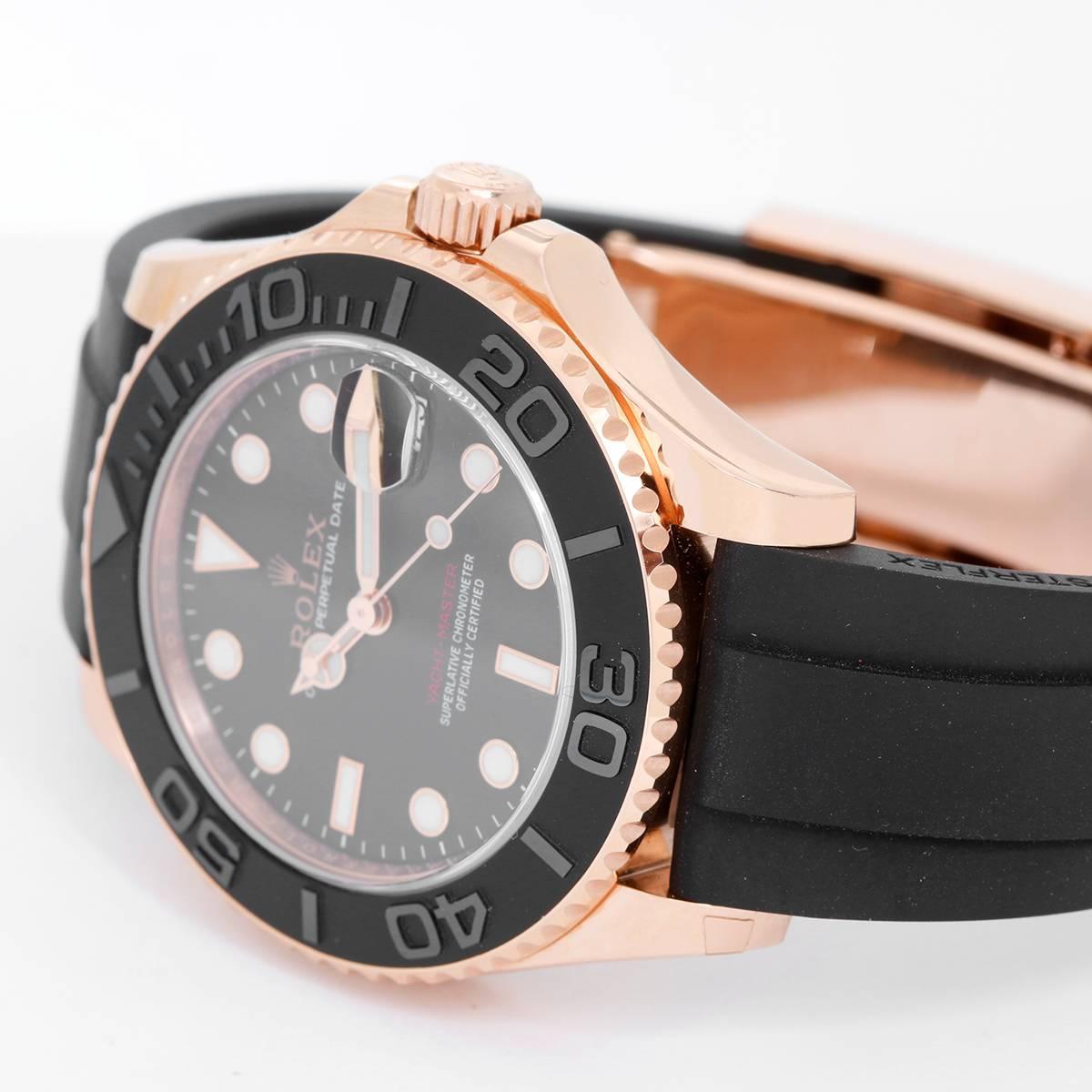 Rolex 18k Everose Rose Gold Yacht-Master  Black Rubber Strap Watch -  Automatic winding. 18k rose gold Everose case (37mm diameter). Black dial with luminous-style markers. Black rubber strap band and 18k rose gold Rolex deployant clasp. Pre-owned