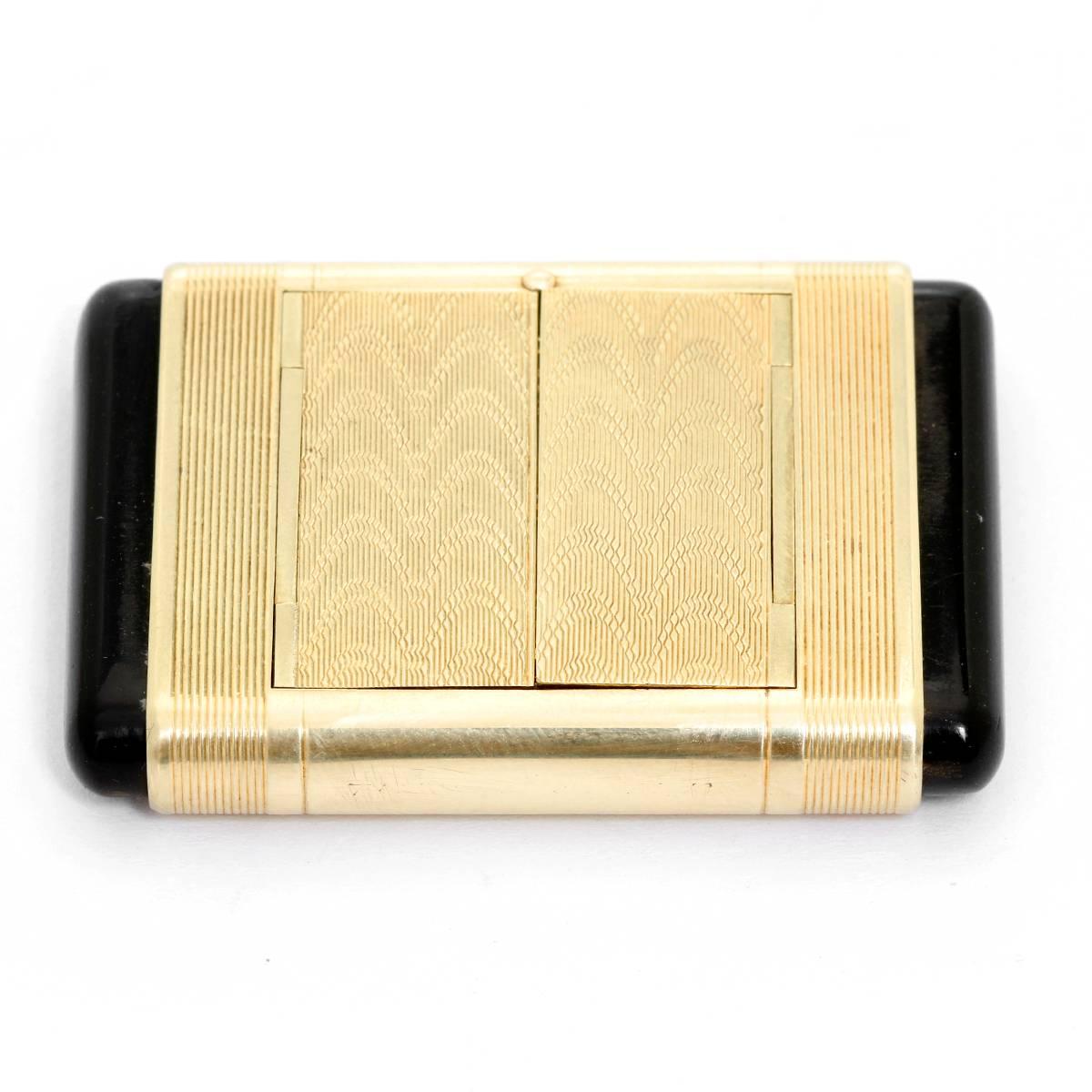 Vintage Art Deco Cartier 14K Gold & Black Enamel Shutter Watch -  Manual winding. 14K Yellow Gold rectangular case with Black Enamel push buttons.  Art Deco Zig zag motif engraved on it. White dial with Arabic numerals. Pre-owned with original