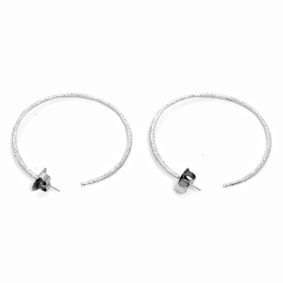 18K White Gold Hammered Earring Hoops - . 1 3/4 in diameter. .2 mm in thickness. Total weight of 7.7 grams. Perfect for an every day look.