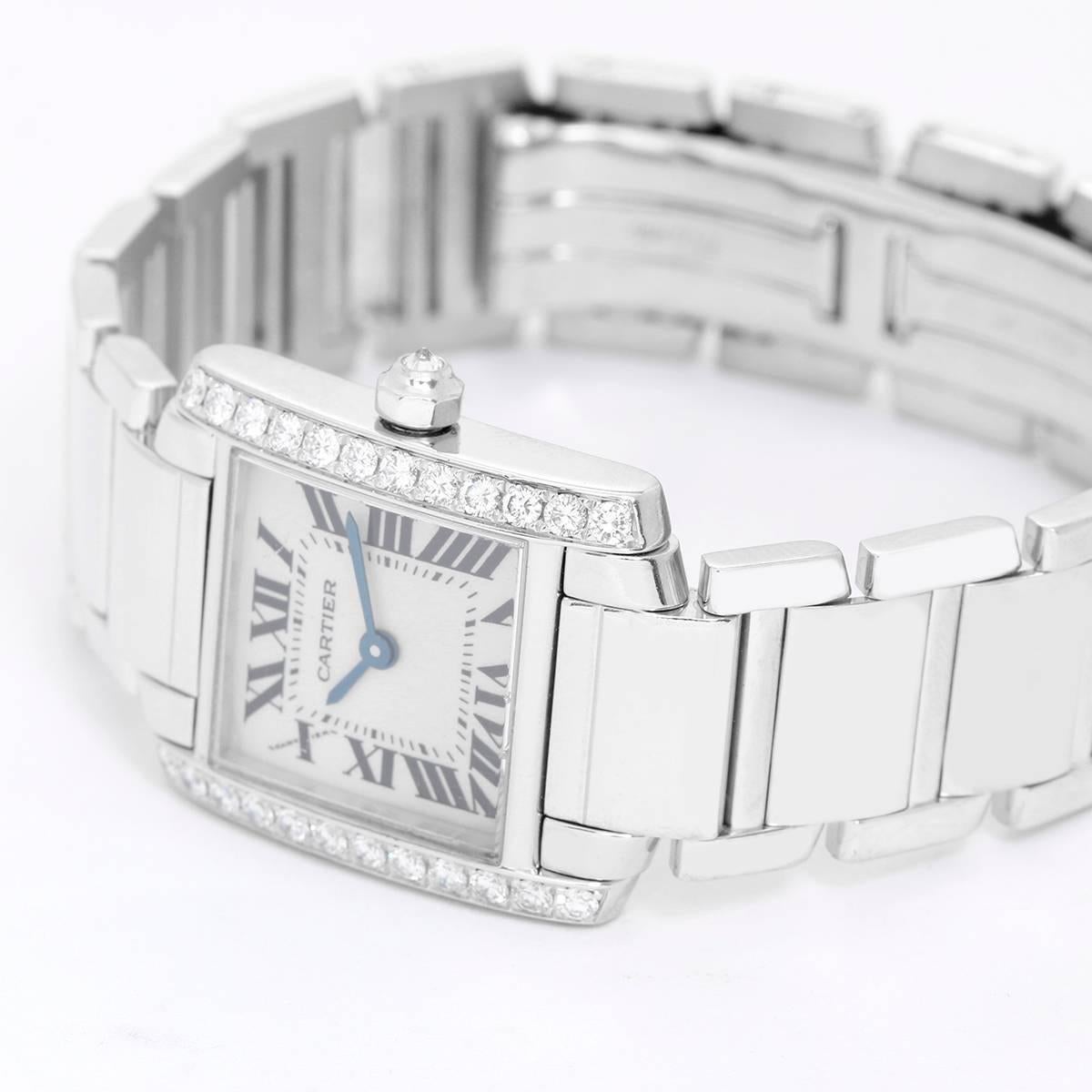 Cartier Tank Francaise 18k White Gold & Diamonds Ladies Watch WE1002S3 -  Quartz. 18k white gold case with factory diamond bezel (20mm x 25mm). Ivory colored dial with black Roman numerals. 18k white gold Cartier bracelet with deployant clasp.