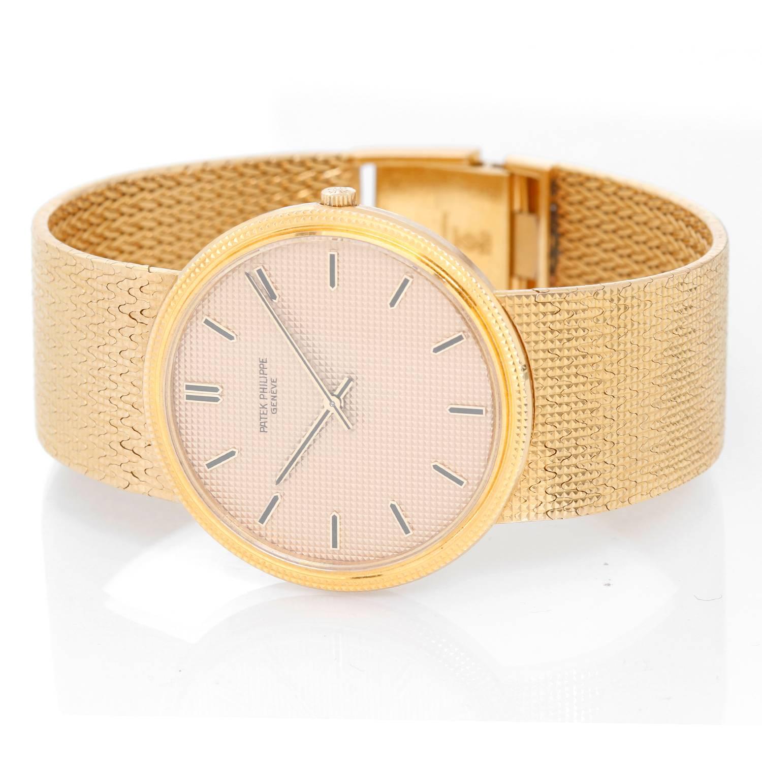 Patek Philippe & Co. 18K Yellow Gold Calatrava 3611 / 1 -  Manual. 18K Yellow Gold hobnail pattern bezel ( 33 mm). Gold textured dial with yellow gold hour markers. 19K Yellow Gold Patek Philippe bracelet. Pre-owned with custom box. 7 inch bracelet