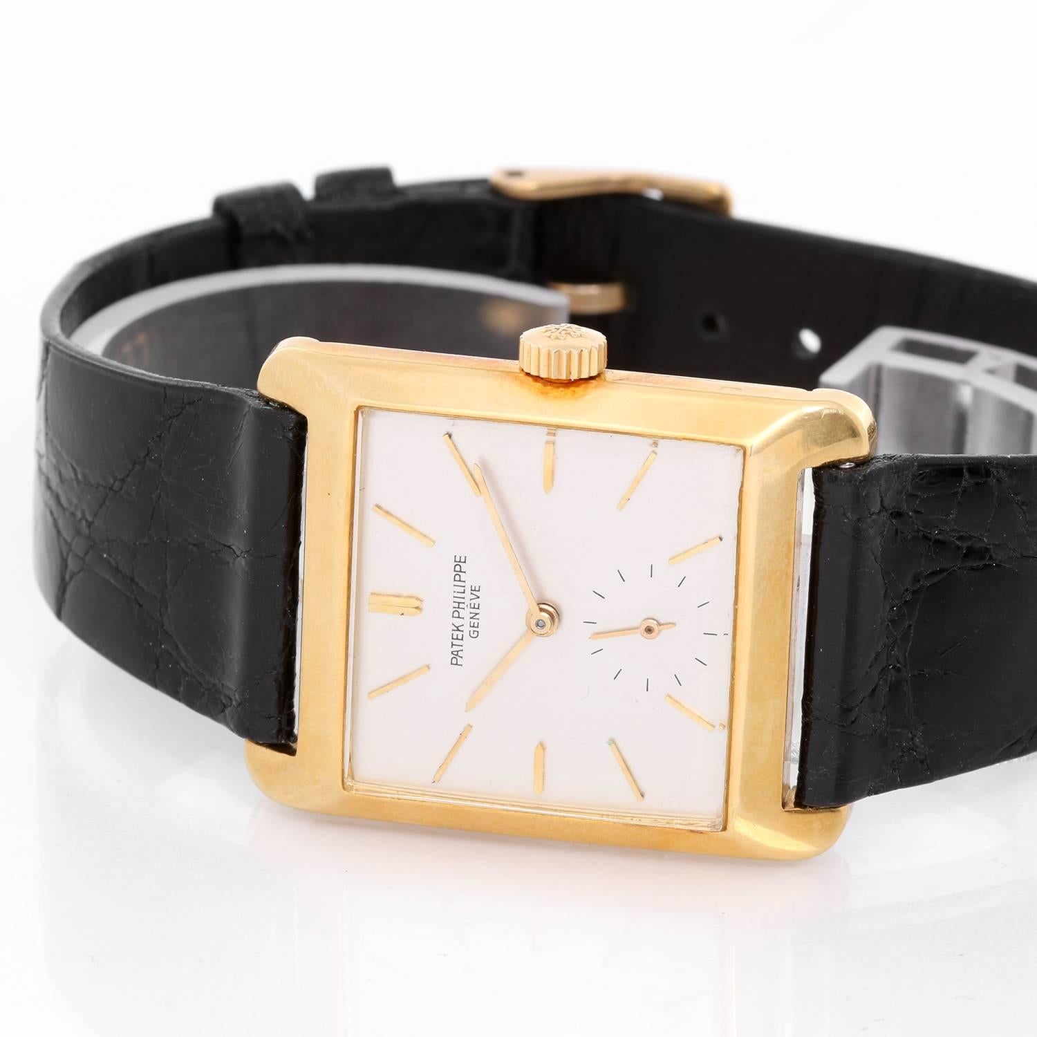 Vintage Patek Philippe & Co. 18K Yellow Gold Watch Ref 2488 -  Automatic winding. 18k Yellow Gold Case (28x35mm). Silvered dial with raised stick hour markers; subsecond at 6 o'clock. Black strap band with gold tone buckle. Pre-owned vintage.