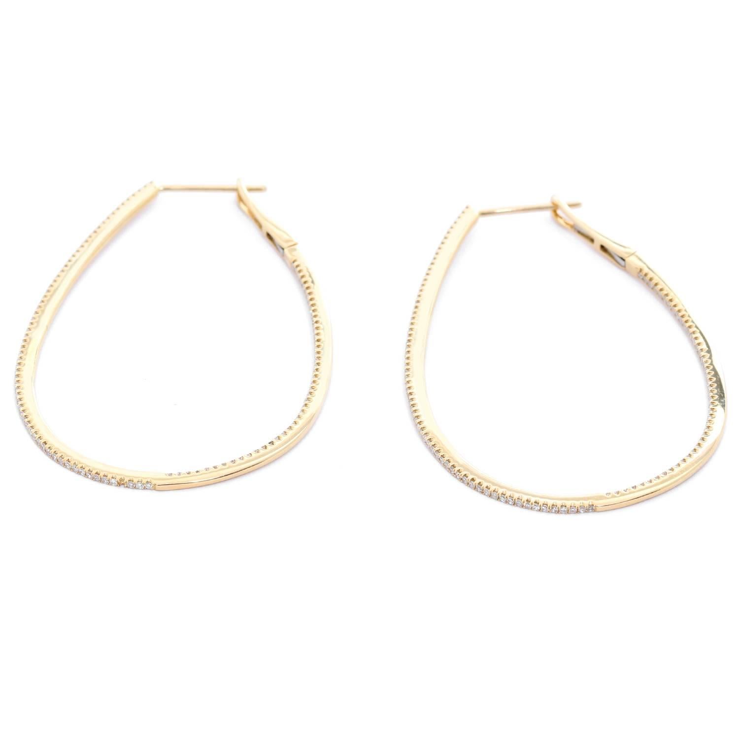 Stunning Tear Drop Inside-Out Diamond Hoops - . 14K Yellow Gold measuring 2 inches long with .65 cts diamonds along the diameter. Clarity SI- Color GH. Total weight 6.3 grams.