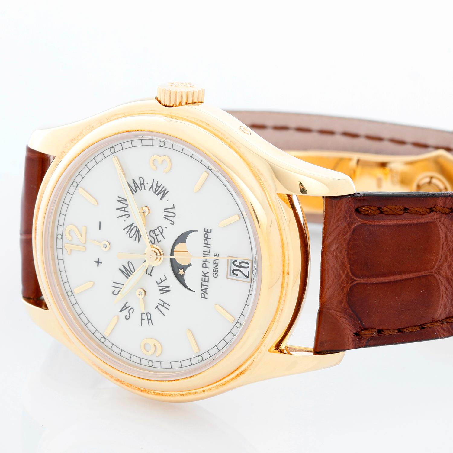 Patek Philippe Annual Calendar Yellow Gold Men's Moonphase Watch 5146J (5146 J) - Automatic winding; day, date, month and moonphase. 18k yellow gold case with exposition back to view movement (39mm diameter). Cream colored dial with gold Arabic