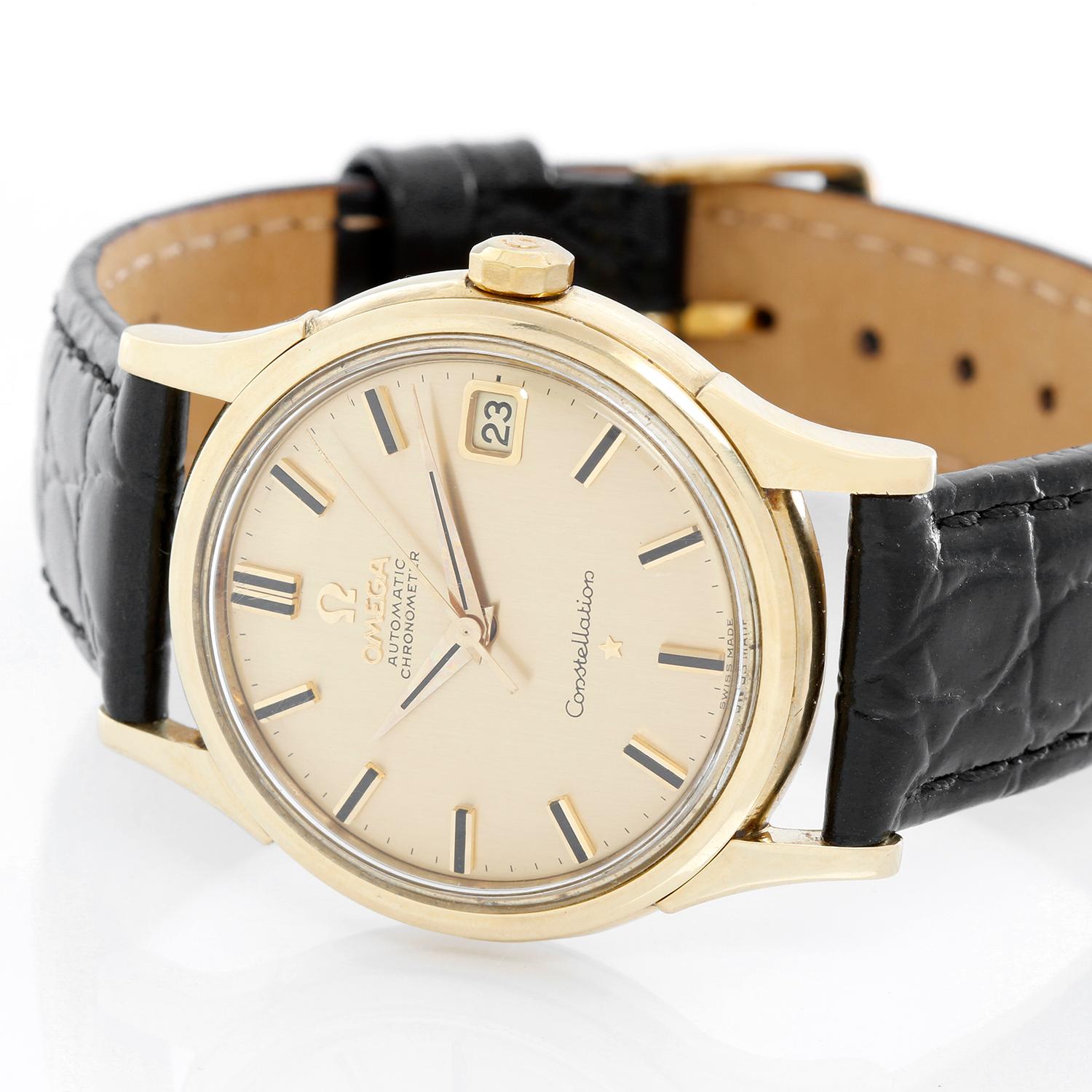 Omega Constellation Automatic 18K Yellow Gold Watch - Automatic . 18K Yellow gold case ( 34 mm ) . Champagne dial with raised stick hour markers . Black leather strap with tang buckle . Pre-owned with custom box .