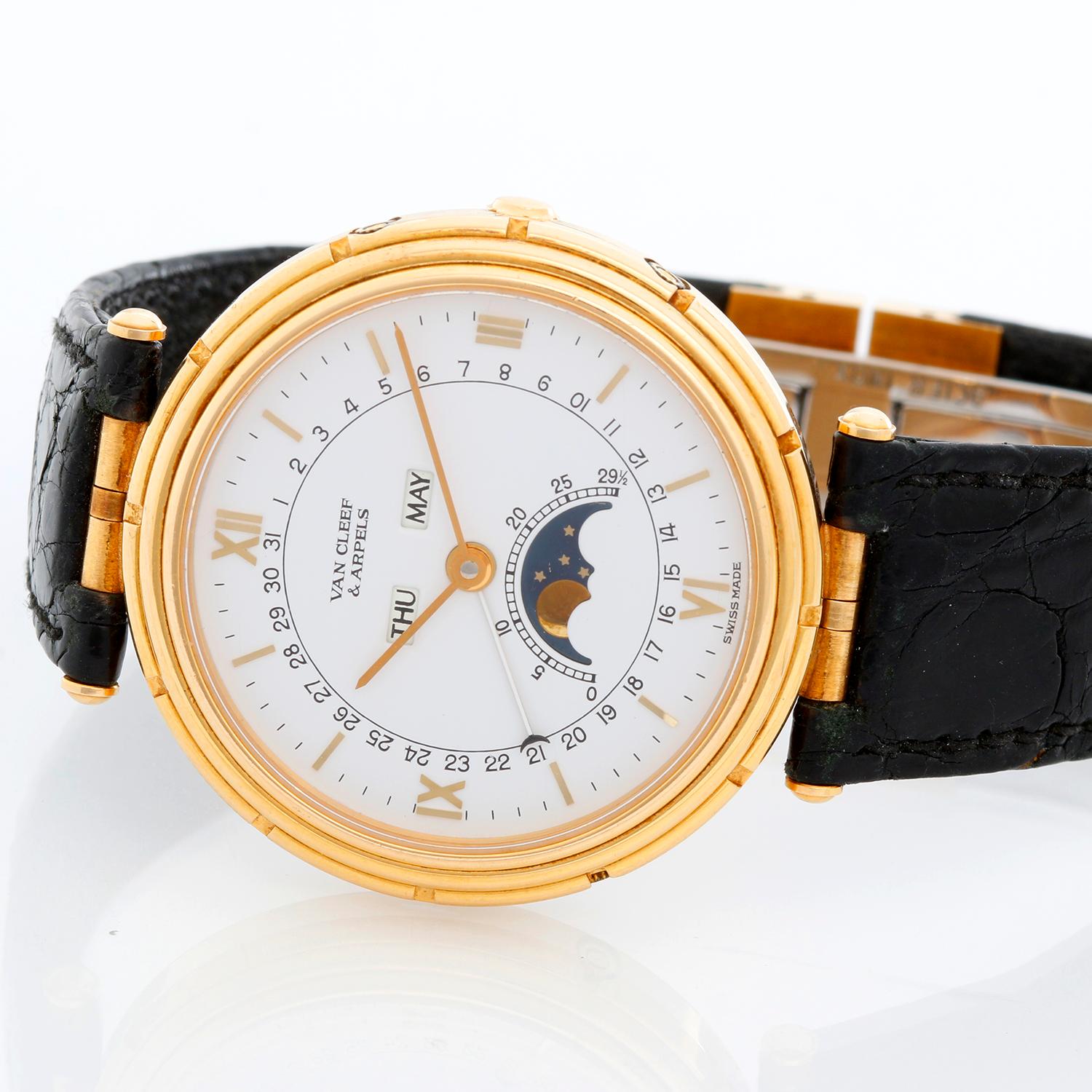 Van Cleef & Arpels 18K Yellow Gold La Collection Ladies Watch - Quartz. 18K Yellow gold ( 35 mm ). White dial with stick hour markers and Roman numerals ; Moonphase and Calendar. Black alligator strap with deployant buckle. Pre-owned with Van Cleef