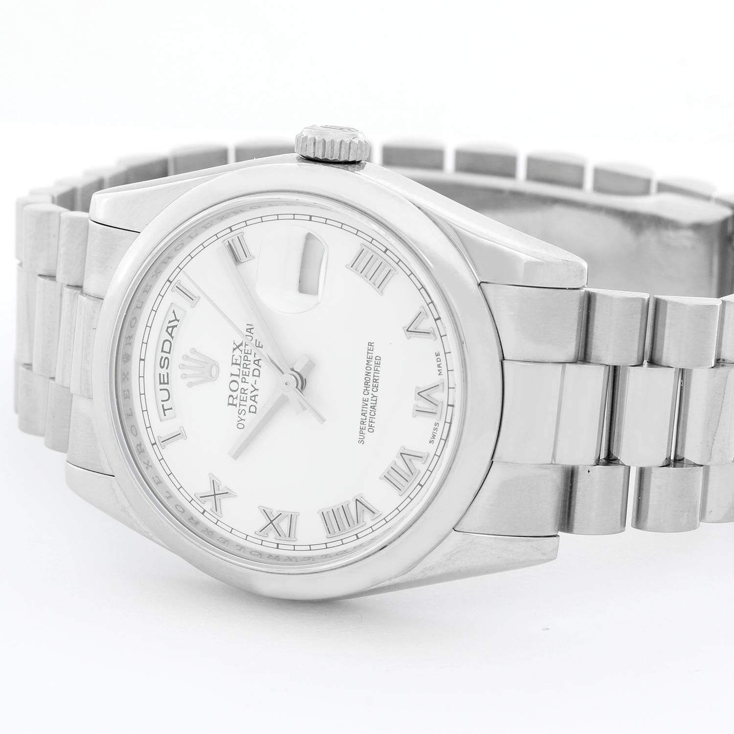 Rolex President Day-Date Men's 18k White Gold Watch 118209 - Automatic winding, 31 jewels, Quickset, sapphire crystal. 18k white gold case with smooth bezel (36mm diameter). White dial with Roman numerals . 18k white gold hidden clasp Oyster