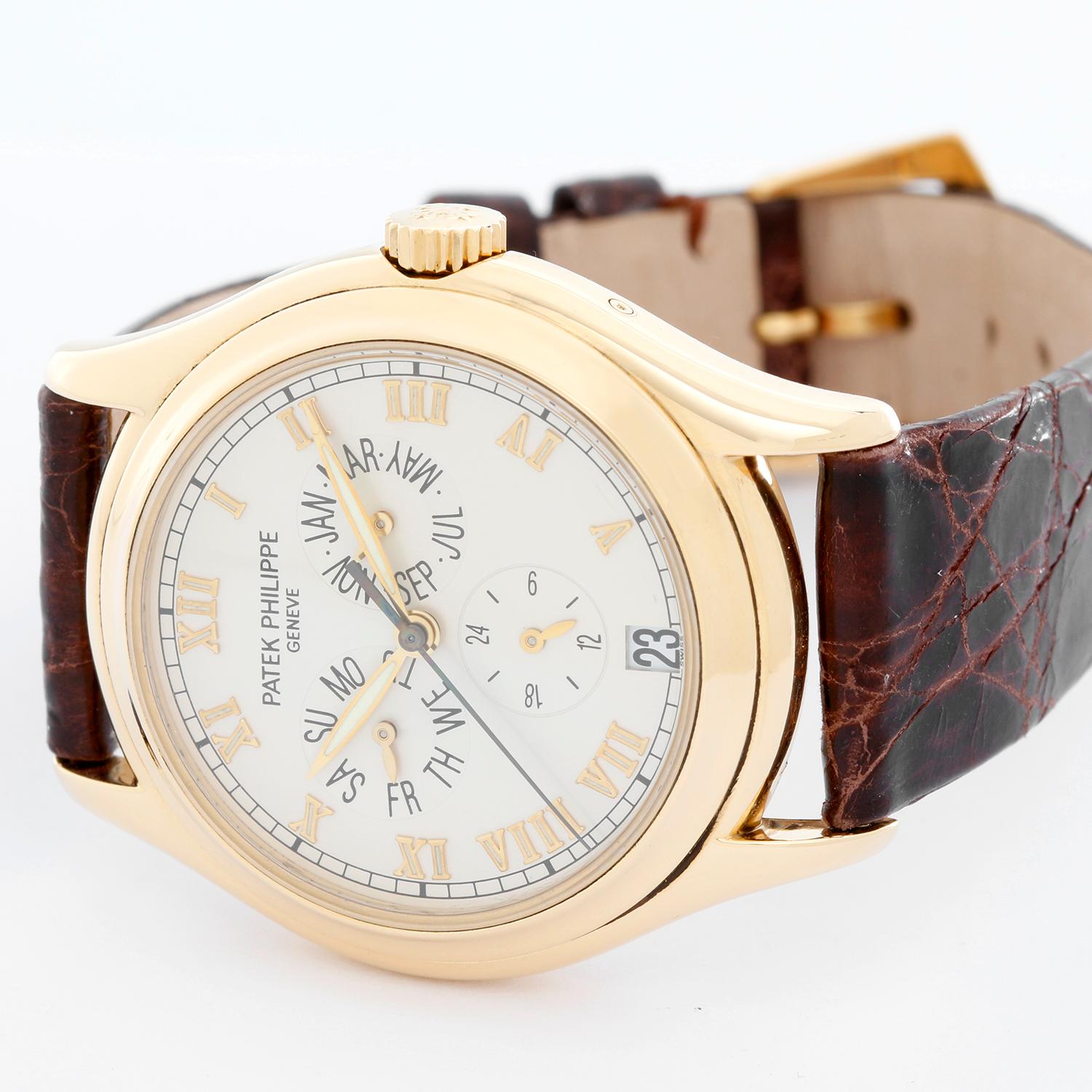 Patek Philippe Annular Calendar 18k Yellow Gold Men's Watch 5035 J (or 5035j) - Automatic winding. 18K yellow gold case with exposition back to view movement (37mm diameter). Silver dial with raised gold Roman numerals; triple calendar & 24 hour