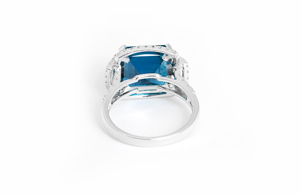 This amazing ring features one 9.40 carat London blue topaz (11mm) surrounded by 0.46 carats of diamonds set in 18k white gold. Total weight is 5.2 grams. Size 7-1/2. This ring is perfect for any event or special occasion!