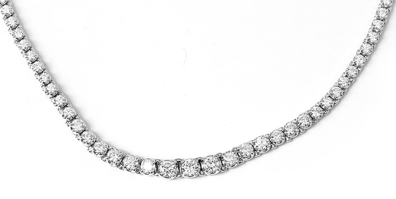 This stunning necklace features round brilliant cut, SI2-VS2  clarity and G-color,  7.00 ctw. diamonds; graduating from 2.7mm to 4.5mm.  Necklace measures apx. 18-inches in length with a figure eight safety clasp. Total weight is 35.9 grams.