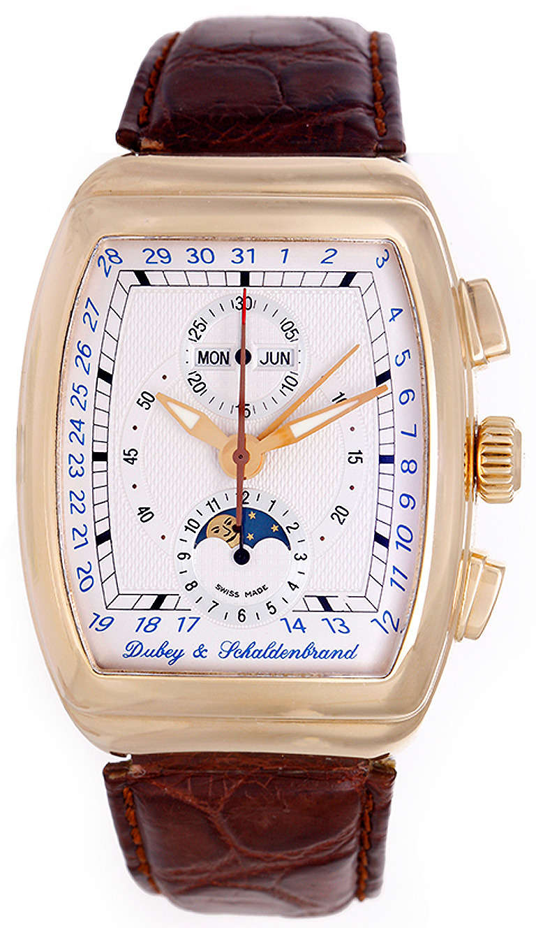 Ref. AGCA/RG/SIB. Automatic movement, 48-hour power reserve chronograph. 18k yellow gold case with exposition back, 38mm x 49mm. Ivory-colored guilloche dial with hour, minute and seconds registers, day, date and moonphase apertures. Dubey &