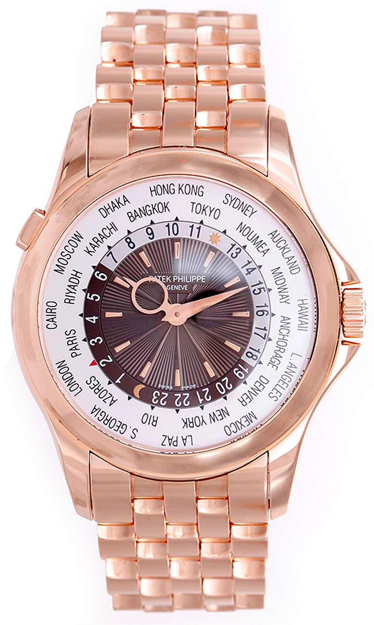 Automatic movement. 18k rose gold case, 40mm. Two-tone silvered and brown guilloche dial, world cities and second time zone, outer day and night indicator ring. 18k rose gold Patek Philippe bracelet. Unused with box and papers.