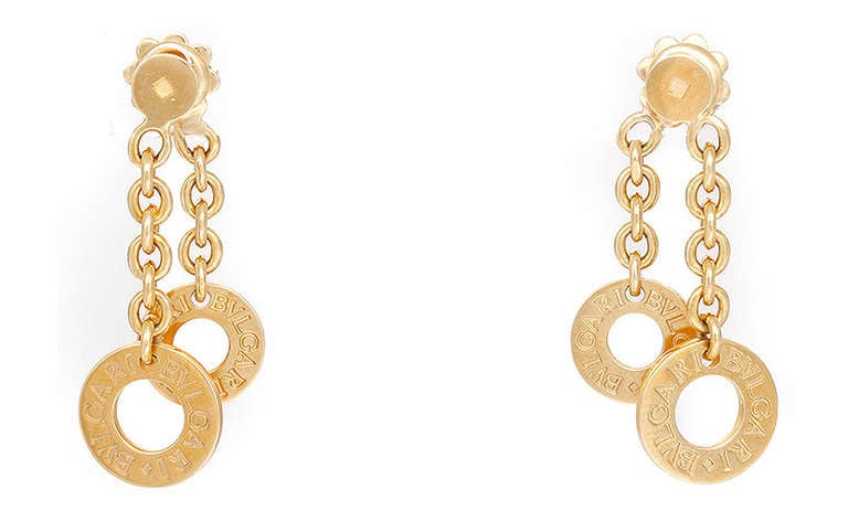 Each of these genuine Bulgari earrings feature 2 chains suspending a disc marked BULGARI BULGARI. Chains and discs are 18k yellow gold and stamped 