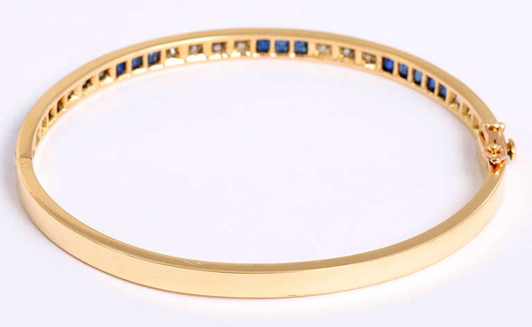 This stunning 18K yellow gold bracelet features VS quality diamonds with an apx. weight of 1 carat and high quality sapphires with an apx. weight of 1.25 carats. The bracelets inside circumference is 6 inches and the bracelet has a total weight of