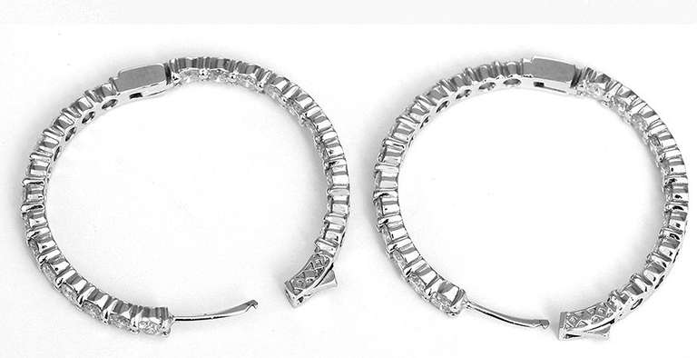These amazing hoops feature 7.55 carats of VS2 H color stones for an unbelievable quality earring.. They measure 1-1/2 inch in diameter and have a total weight of 16.6 grams. These earrings feature a push button closure for safety..