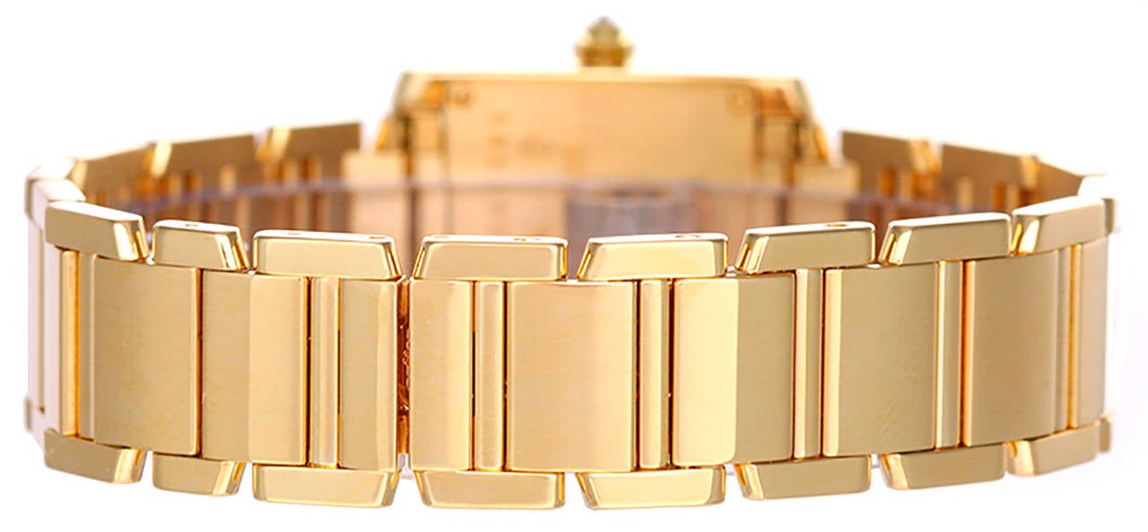 Quartz. 18k yellow gold case with factory diamonds (20mm x 29mm). Ivory colored dial with black Roman numerals. 18k yellow gold Cartier Tank Francaise bracelet with deployant clasp. Pre-owned with Cartier box and books.