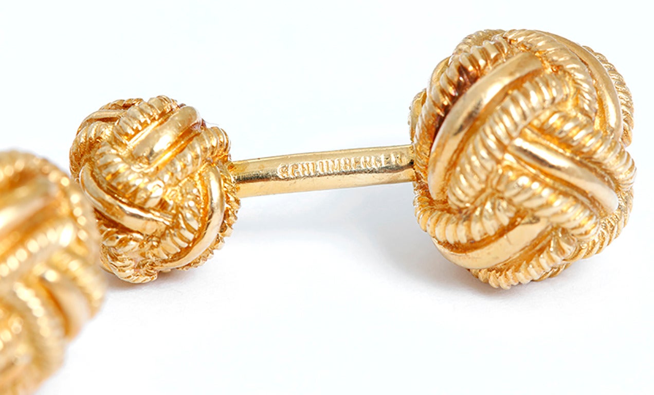 These  Schlumberger for Tiffany & Co. cufflinks feature a double rope knot design in 18k yellow gold. Cufflinks measure apx. 1-1/8 inches in length.  Larger ball measures apx. 1/2-inch in diameter, smaller measures apx. 3/8-inch in diameter. Total