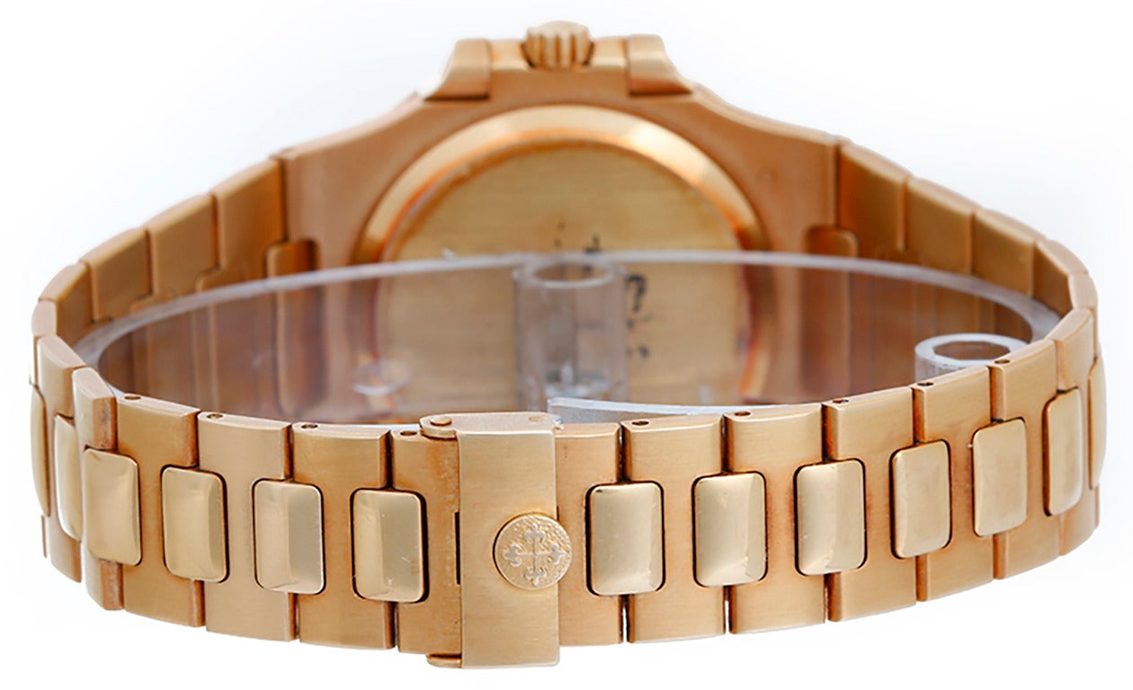 Automatic winding with date. 18k yellow gold case (37mm x 39mm). Charcoal gray dial with gold stick hour markers; date at 3 o'clock position. 18k yellow gold Nautilus bracelet with deployant clasp. Pre-owned with box and papers.

Ref 3800/1 J