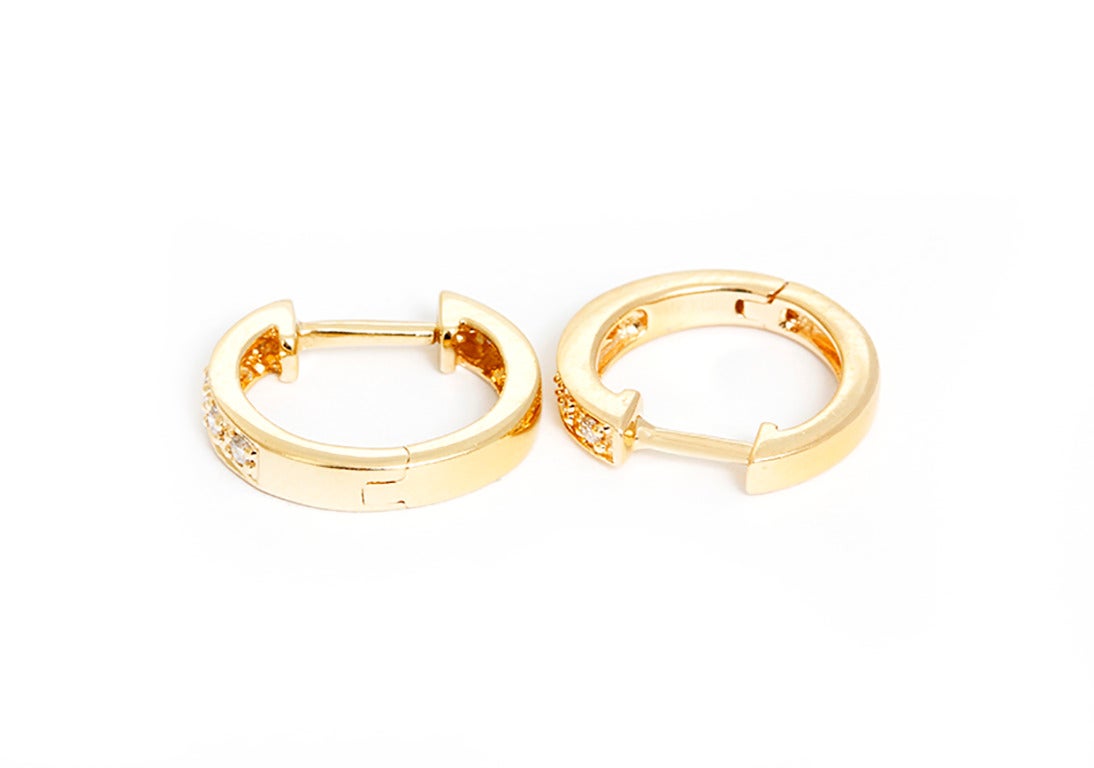 These amazing KC Designs mini hoop earrings feature .10 carats of diamonds set in 14k yellow gold.  Hoops measure apx. 3/8-inch in length, 1/16-inch in width, and 3/8-inch in diameter. Total weight is 1.9 grams. These hoops are perfect for every day