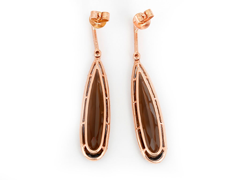 These amazing earrings feature a 12.55 carat smoky quartz and 0.19 carats of diamonds set in 14k rose gold. Earrings measure apx. 1-7/8 inches in length. Total weight is 6.8 grams.