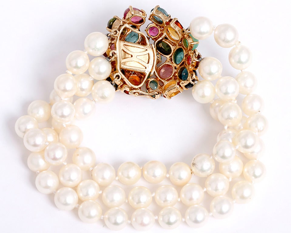 This bracelet features 3 strands of 7mm pearls, each 6 inches in length.  The tutti-frutti clasp opens in the center and  features  tourmalines, amethysts, citrines and diamonds set in 14k yellow gold.  The total length of the bracelet and clasp is
