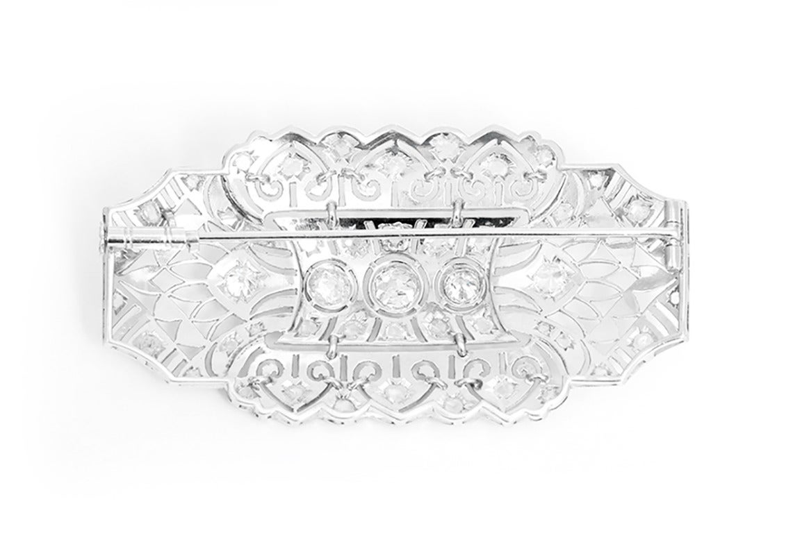 This stunning Art Deco brooch features a pierced reticulated millegrained design with apx. 2.79 ctw. of Old European cut and rose cut diamonds in platinum. Brooch measures apx. 2-1/2 inches x apx. 1-1/4 inches. Total weight is 17.4 grams. Ca. 1938.