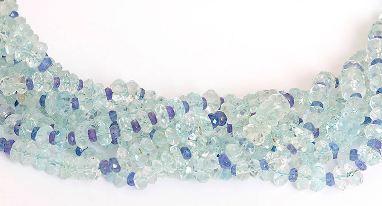 This torsade necklace features eight unknotted strands of faceted aquamarine beads (apx. 5.50 x 1.50 mm - apx. 6.50 x 3.00mm) and faceted tanzanite beads (apx. 3.00 x 1.00mm - apx. 5.50 x 3.50mm) with an 18k white gold clasp. Necklace measures apx.