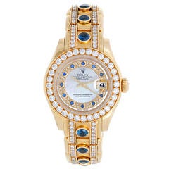 Rolex Lady's Yellow Gold Pearlmaster Mother Of Pearl Myriad Sapphire Wristwatch