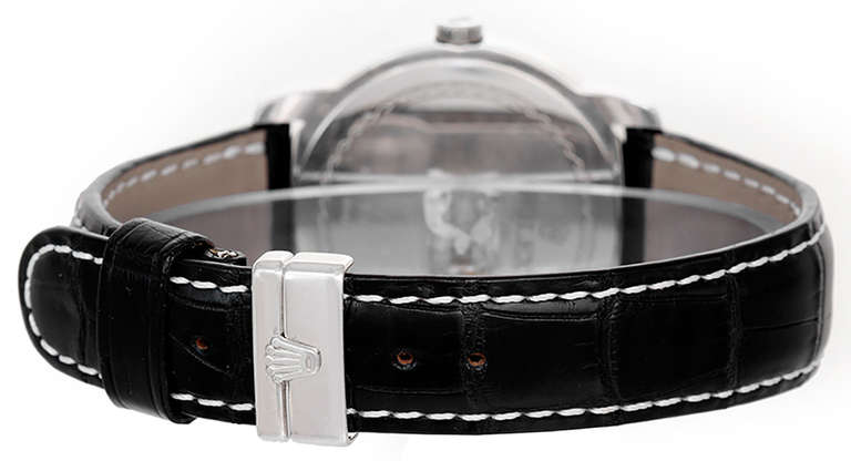 Automatic movement. Platinum case, 38mm. Black dial with baton indexes, subsidiary seconds at 6 o'clock. Black croc strap with platinum Rolex deployant clasp. Pre-owned with Rolex box.
