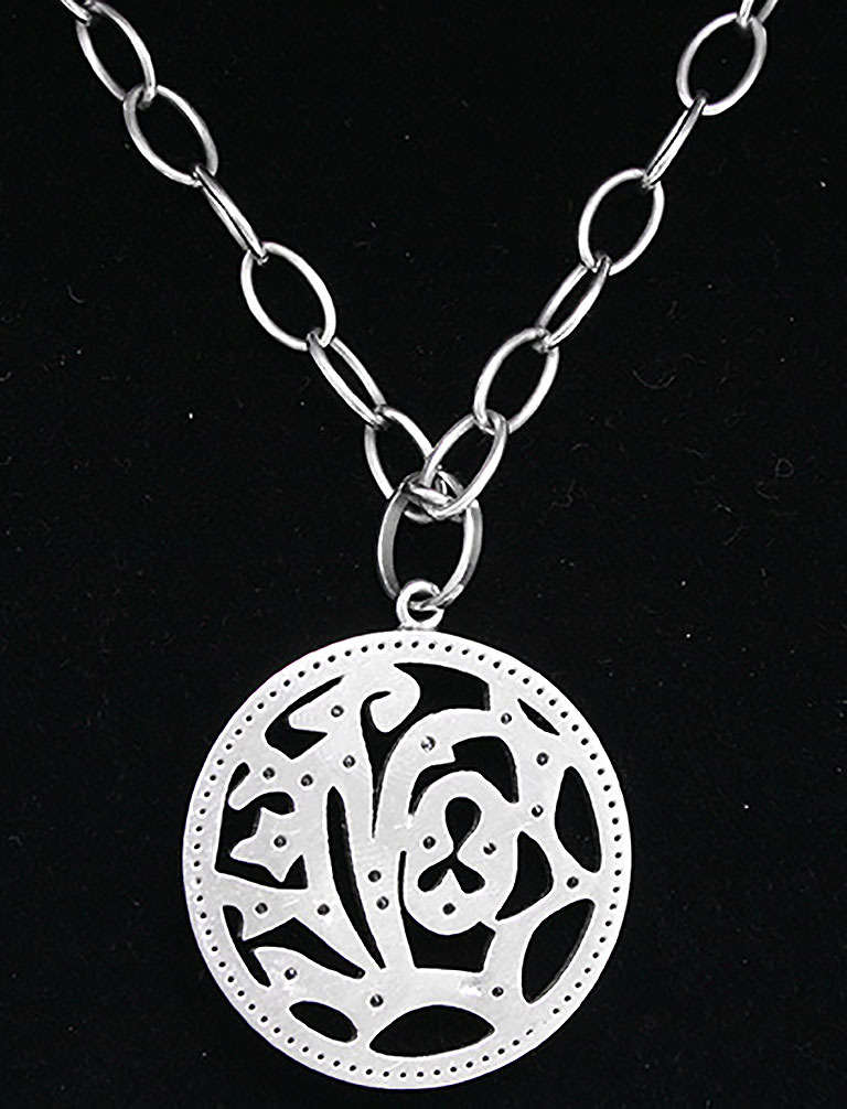 This beautiful pendant is similar to a popular designer. It is round and the diameter is apx. 1-1/2 inches. It has apx. 1 carat of white diamonds sprinkled on it. The pendant weighs 15 grams and the chain weighs 15.6 grams. The chain is 18 inches