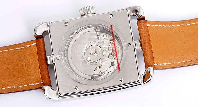 Ref. CD5.810. Automatic movement. Stainless steel case with exposition back, 37mm x 50mm. Two-tone silvered dial with guilloche center square, Arabic numerals, date at 3 o'clock. Strap with stainless steel Hermes deployant clasp. Unused with box and