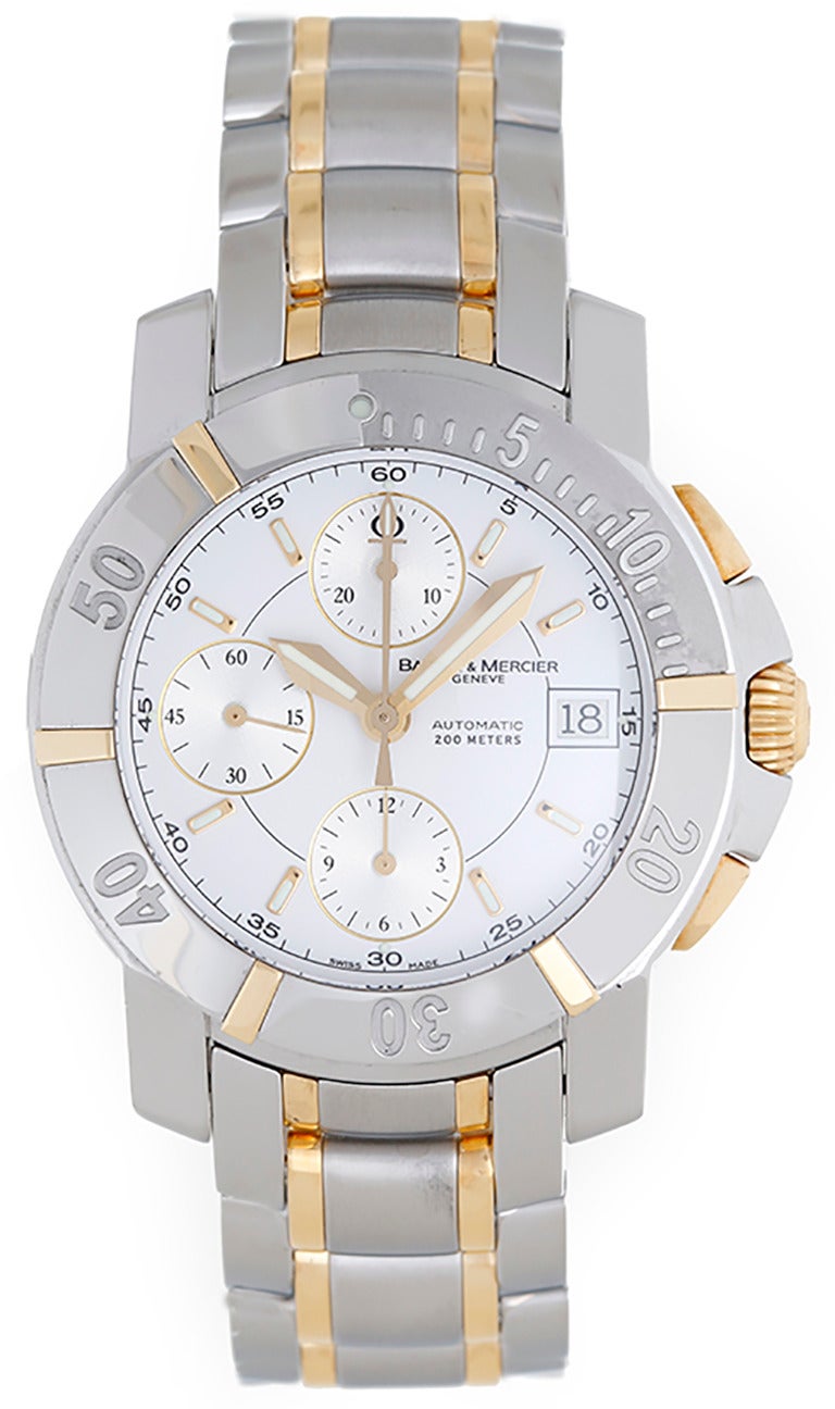 Automatic winding; chronograph. Stainless steel case and bezel with gold accents (42mm diameter). White dial with luminous style markers; hour, minute and seconds recorders; date at 3 o'clock position. Stainless steel bracelet with 18k yellow gold