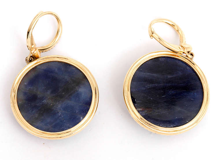 These sapphire round cut faceted earrings feature .28 carat diamonds and measure 7/8- inches in diameter. The total weight of 14.3 grams.