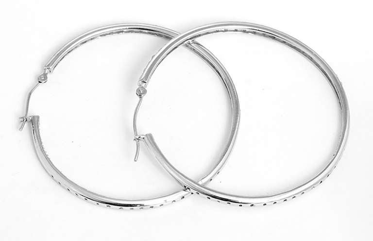 These beautiful 14k white gold diamond hoops feature apx. 0.70 ct. ,  SI1, I color diamonds. The earrings measure 1-5/8 inch in diameter with a total weight of 7.9 grams.