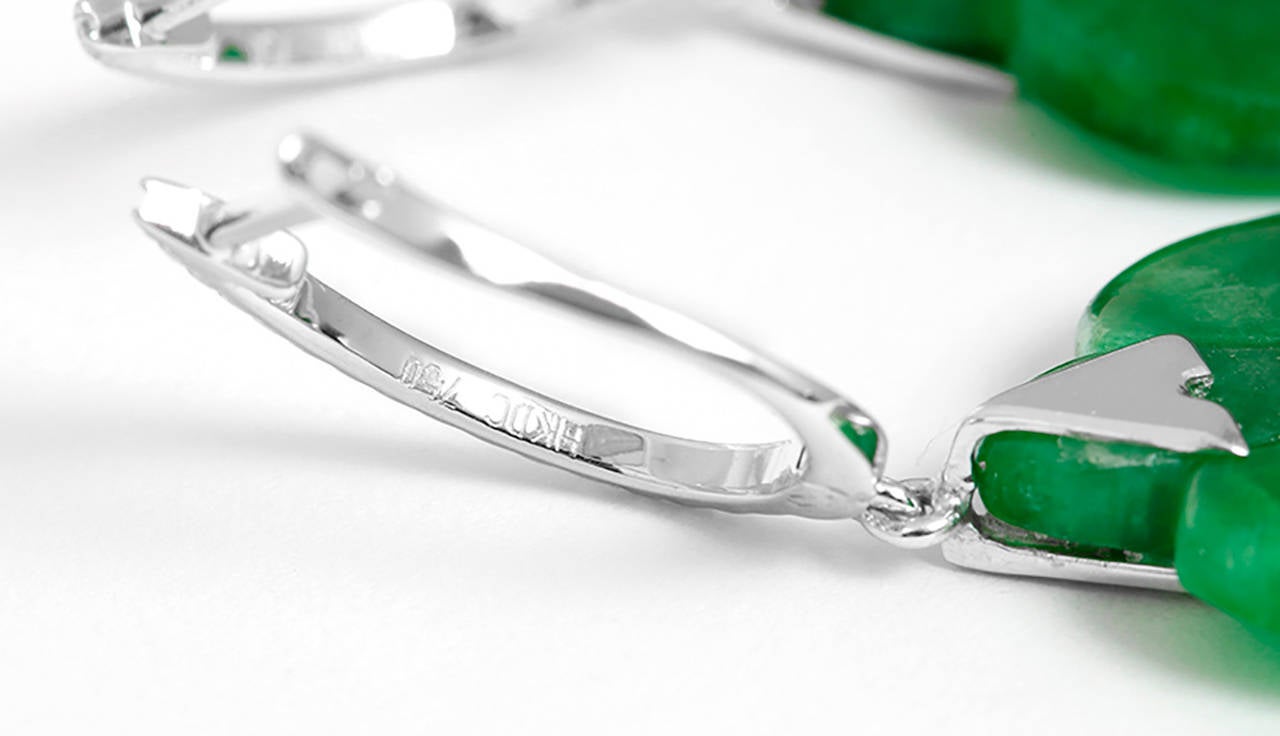 These amazing dangle earrings feature jade and apx. 0.18 carats of diamonds set in 18k white gold. Earrings measure apx. 2-3/4 inches in length with a total weight of 14.0 grams.