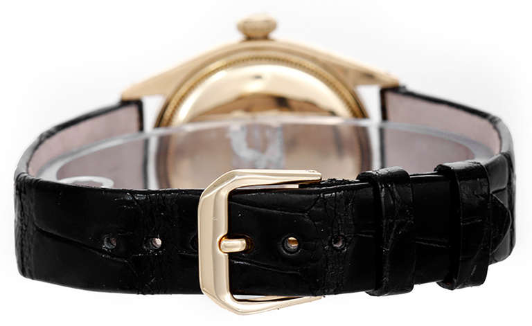 Automatic movement. 18k yellow gold case, 34mm diameter, with finely engine-turned bezel. Gilt dial with factory diamond and gilt dagger hour markers. Circa 1950s. 

This watch is collectible and rare, as it is unusual to find an example from this