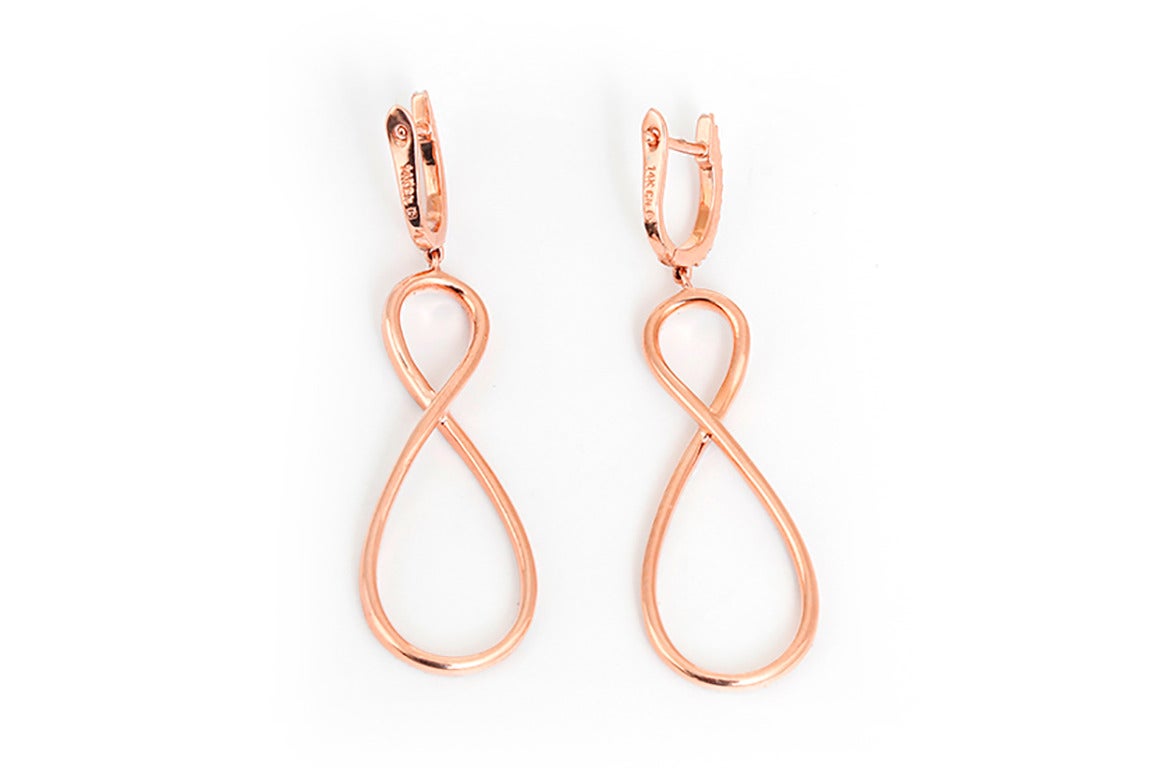 These amazing earrings feature an infinity design with apx. 0.10 carats of pave diamonds (G-H-color and SI1-clarity) set in 14k rose gold. Earrings measure apx. 2-inches in length. Total weight is 6.1 grams.